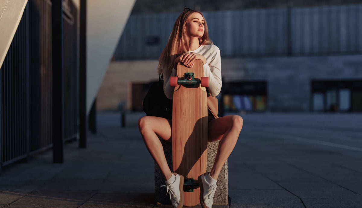 Modern E-commerce Hero Banner for Footwear Theme: Lifestyle shot of a woman with a longboard.